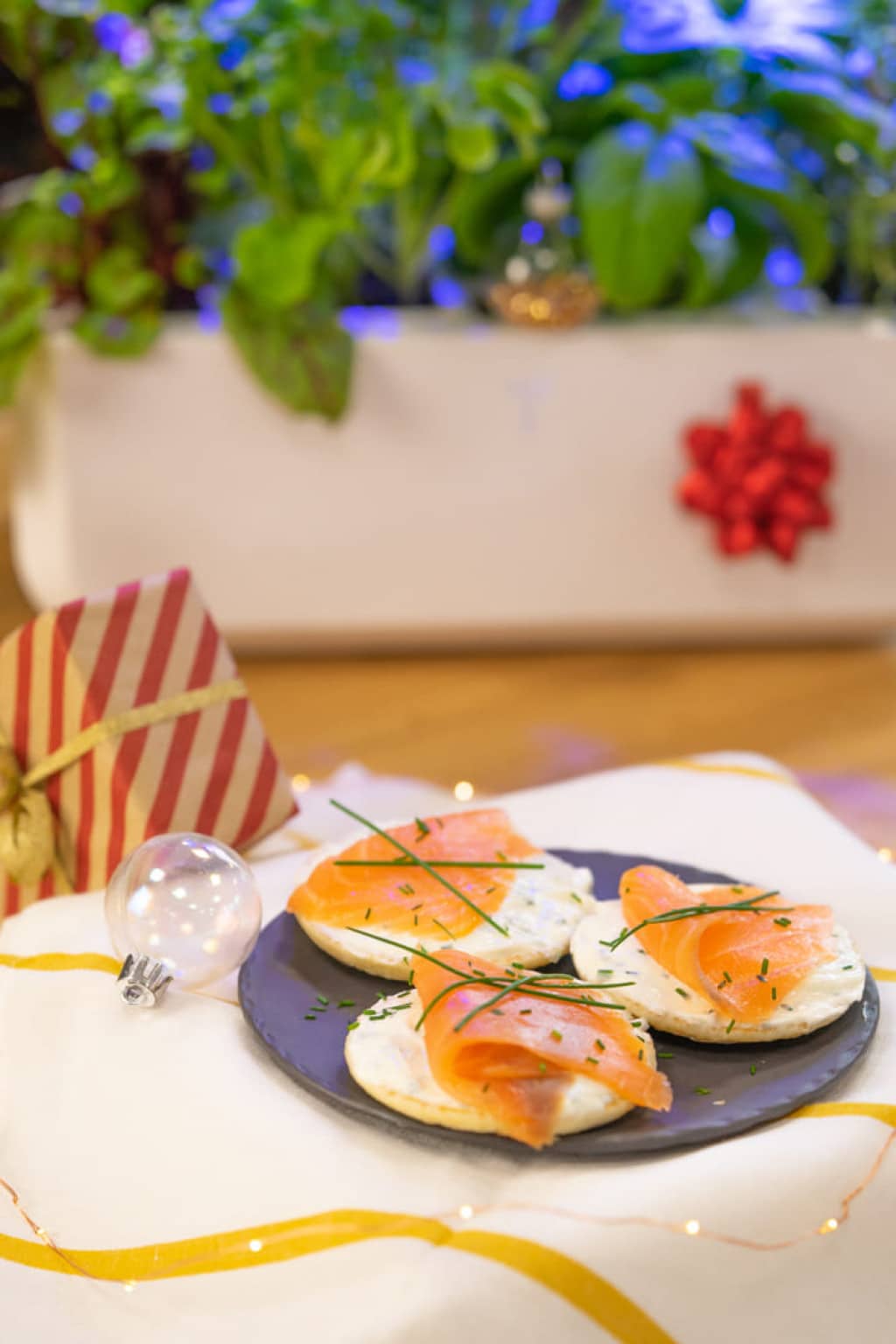 Blinis and fresh cheese with chives, topped with smoked salmon