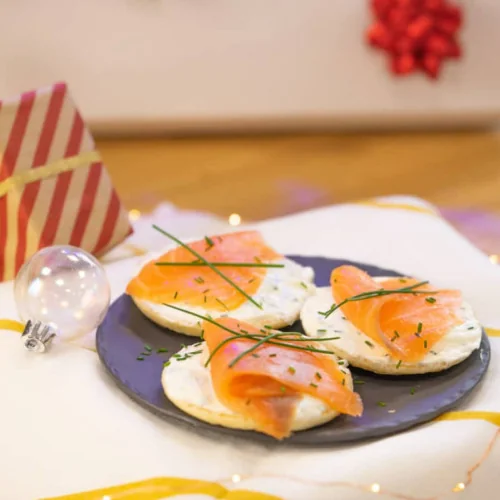 Blinis and fresh cheese with chives, topped with smoked salmon